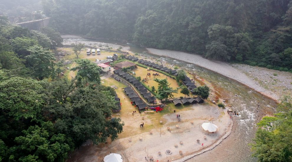 Actual aerial photograph of Hideaway resort, tents, lawns, forest and river